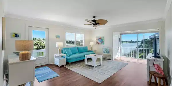 Image 4: Living area featuring wood-finish flooring and crown molding