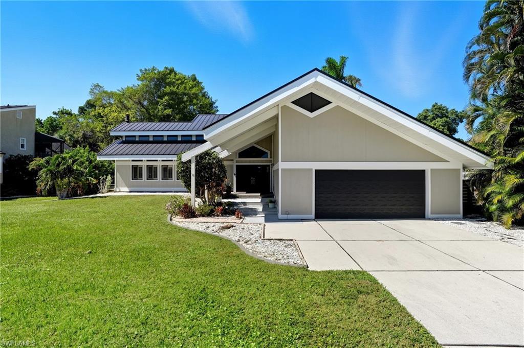 Image 3: Contemporary exterior featuring a gabled roofline, metal roof, and an integrated two-car garage