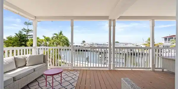Image 3: Covered outdoor deck with canal front views to enjoy the island breezes and wildlife.