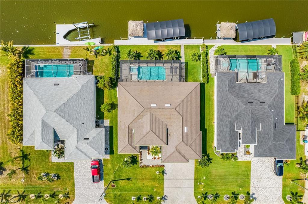 Image 3: Three properties each featuring a private swimming pool, screened enclosure, and direct water frontage