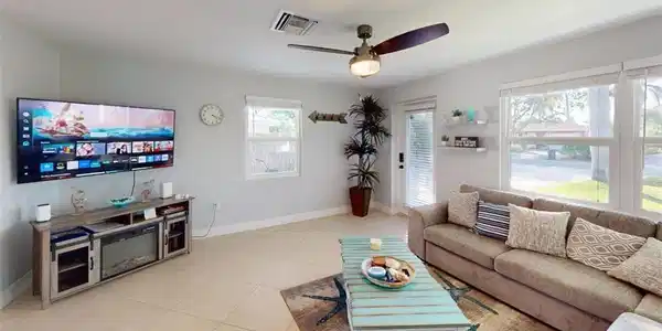 Image 3: Living area with ceiling fan and light tile patterned floors