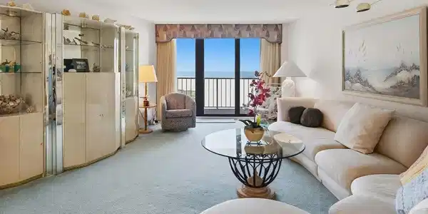 Image 4: Built-in display cabinetry, floor-to-ceiling glass doors, and light-colored carpeting