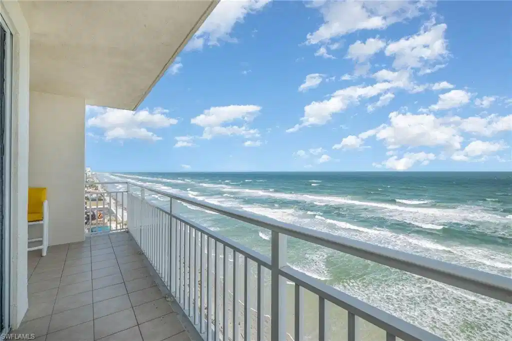 Image 1: Balcony with view of water and beach
