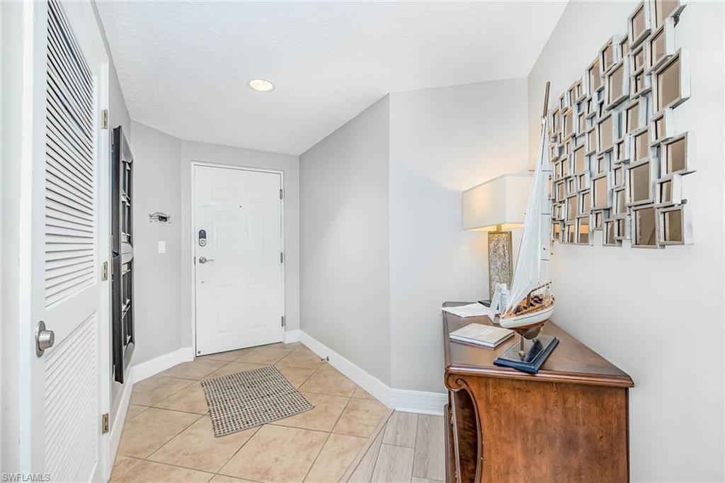 Image 3: Foyer featuring light tile patterned floors and recessed lighting