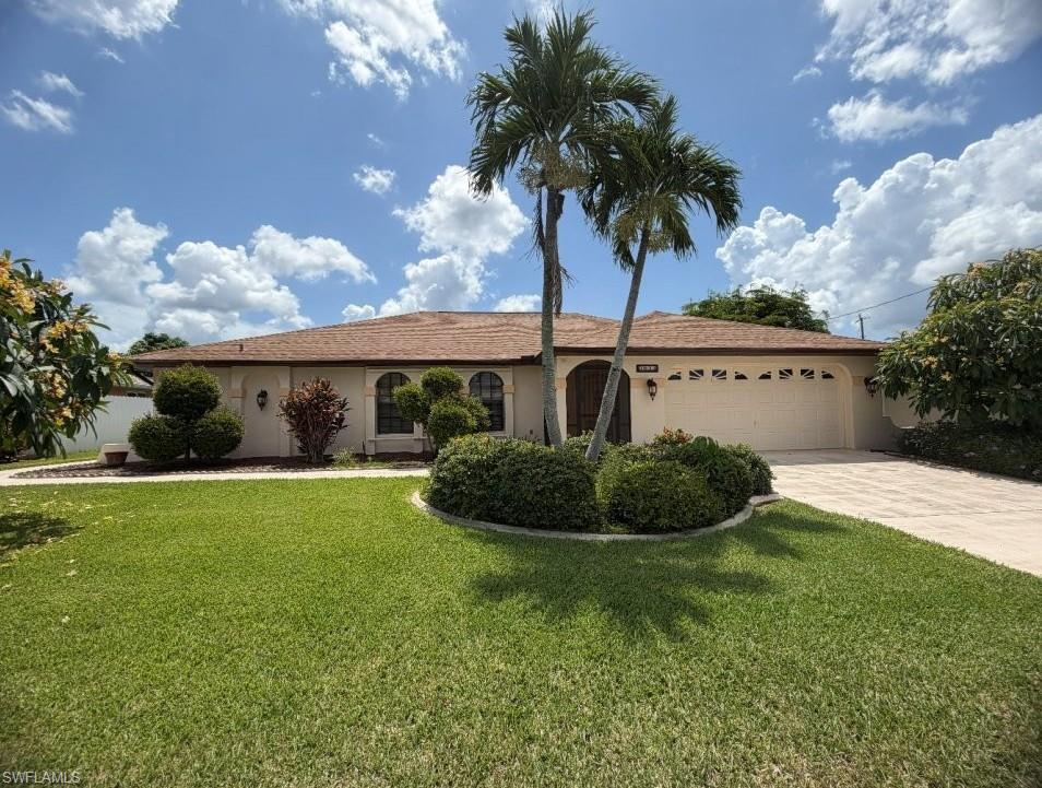 Image 1: Single-story residence featuring a tan exterior and a brown shingle roof