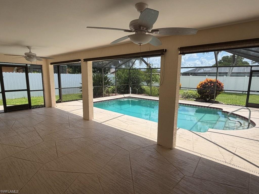 Image 2: Screened lanai featuring a swimming pool, integrated spa, and expansive patio with ceiling fans