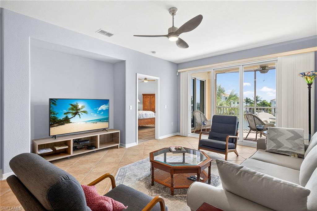 Image 4: Living area with light tile patterned flooring and ceiling fan