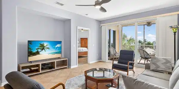Image 4: Living area with light tile patterned flooring and ceiling fan