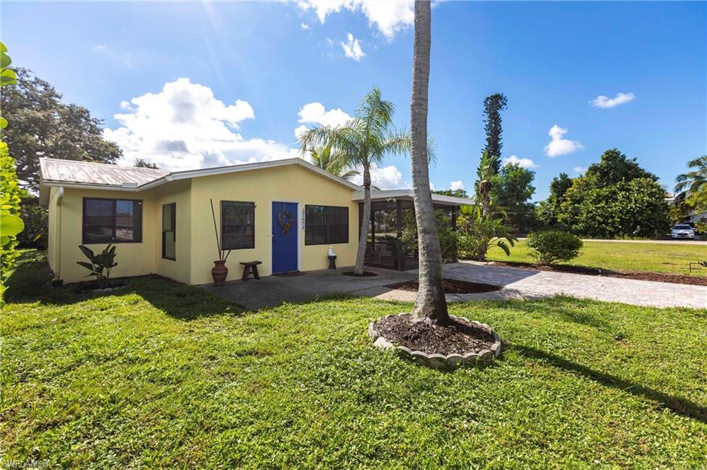 Image 2: View of your front yard, patio, NEW decorative driveway, and metal roof