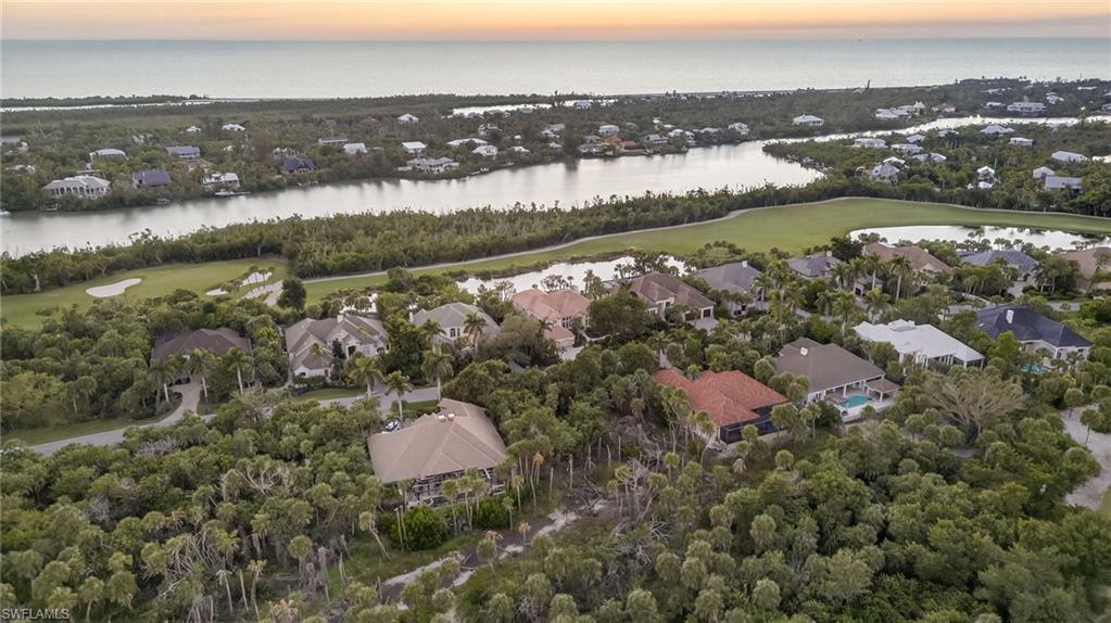 Image 2: Aerial view of property and surrounding area with nearby suburban area, a large body of water, and a golf club