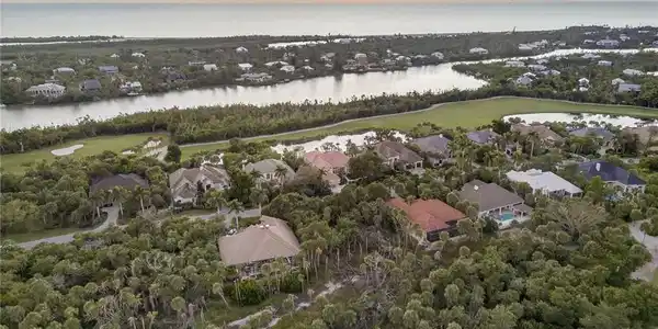 Image 2: Aerial view of property and surrounding area with nearby suburban area, a large body of water, and a golf club