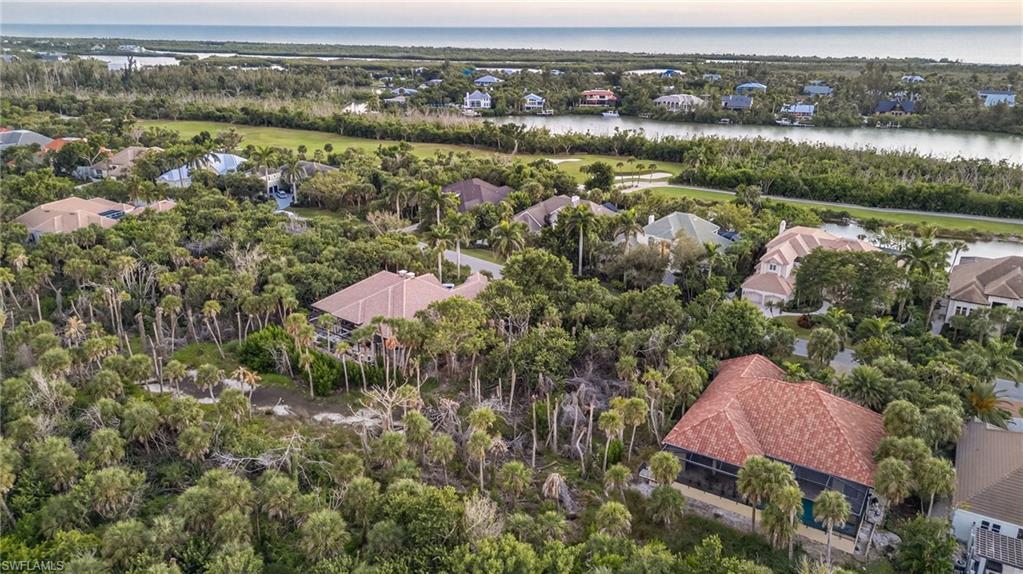 Image 3: Aerial view of residential area with a large body of water