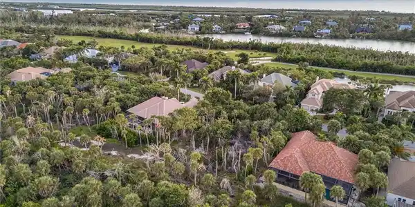 Image 3: Aerial view of residential area with a large body of water