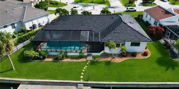 Image 2: Stunning aerial view showcasing the homes layout and water front