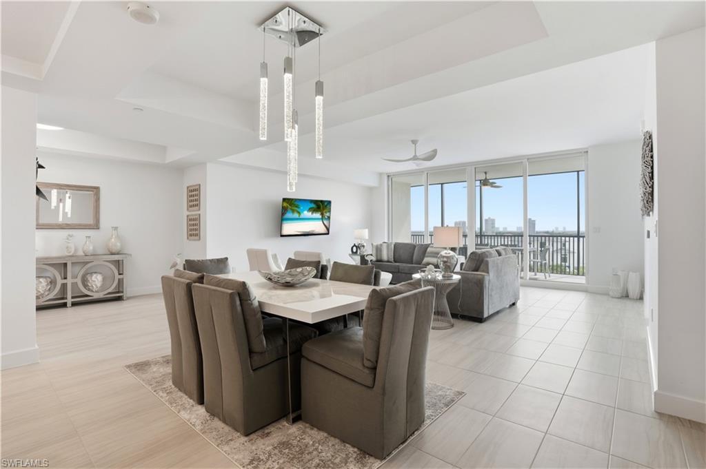 Image 2: Dining area with breathtaking views of the beautiful Fort Myers beach out of your sliding  impact glass doors. Virtually edited
