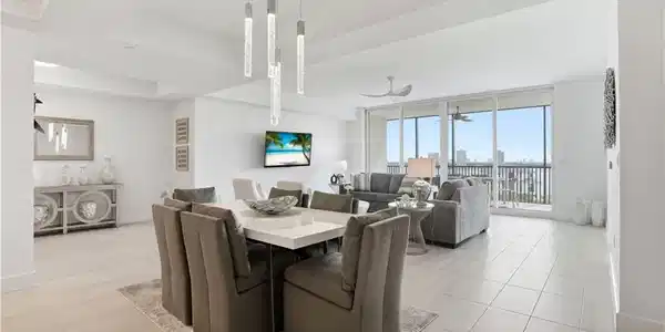 Image 2: Dining area with breathtaking views of the beautiful Fort Myers beach out of your sliding  impact glass doors. Virtually edited