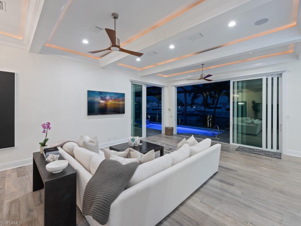 Image 4: Living room featuring ceiling fan, beamed ceiling, and light hardwood / wood-style flooring