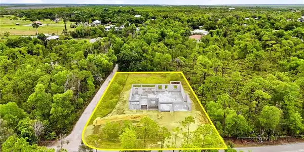 Image 4: Construction is underway on this three-bedroom-plus-den pool home.