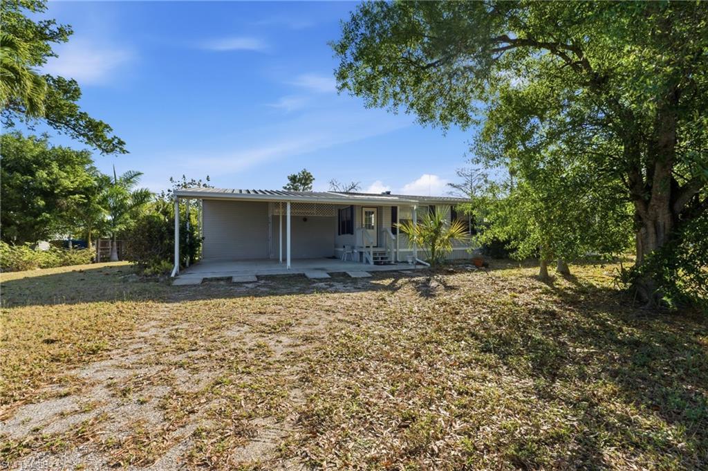 Image 4: View of front of house with a patio, an attached carport, and a front yard