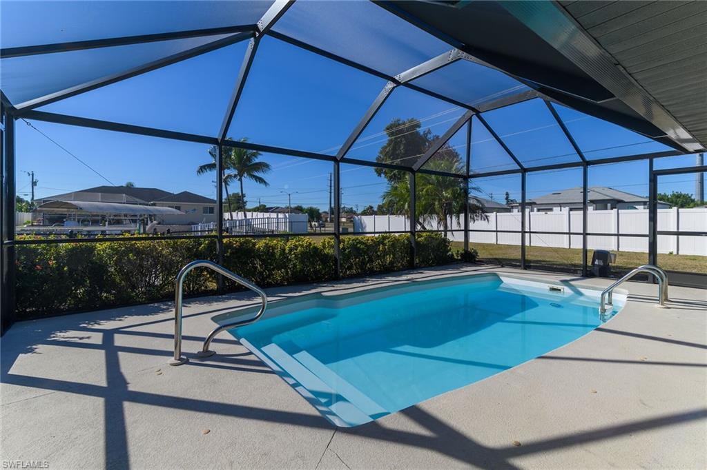 Image 2: View of pool with a lanai, a sunroom, and a patio area