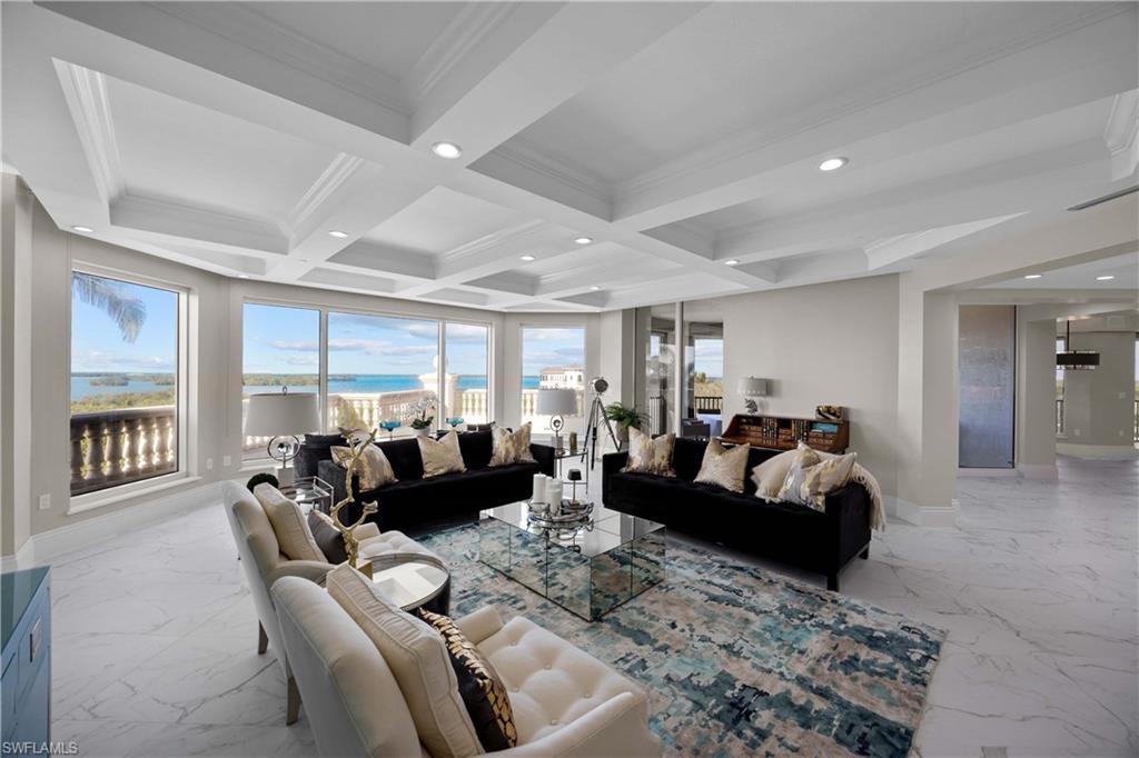 Image 1: Living room with beamed ceiling, a healthy amount of sunlight, ornamental molding, and coffered ceiling
