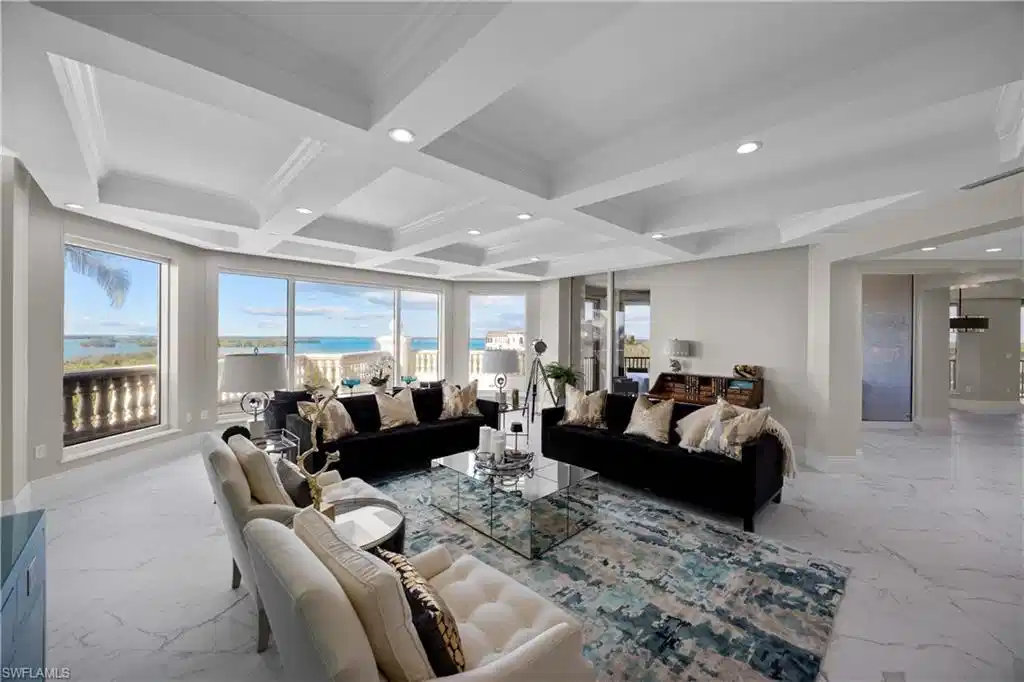 Image 1: Living room with beamed ceiling, a healthy amount of sunlight, ornamental molding, and coffered ceiling