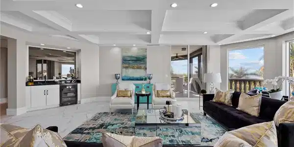 Image 2: Living room featuring beam ceiling, crown molding, beverage cooler, and coffered ceiling