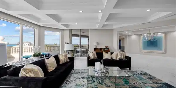 Image 3: Living room featuring beam ceiling, ornamental molding, and coffered ceiling