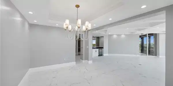 Image 4: Unfurnished room with a tray ceiling, baseboards, recessed lighting, and a chandelier
