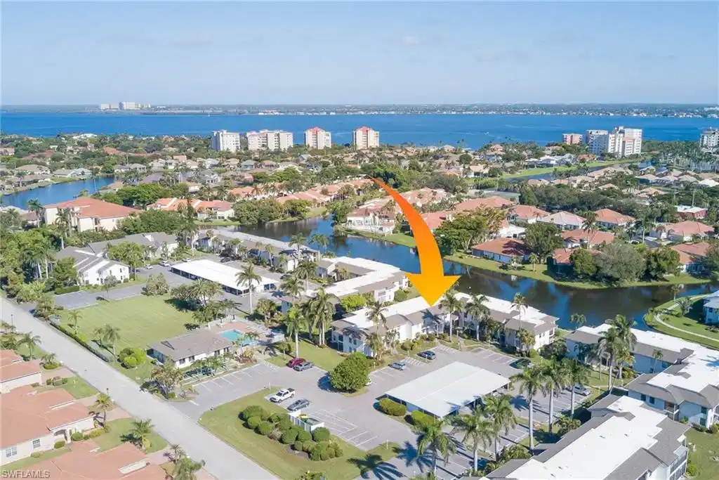 Image 1: Aerial view of residential area with a large body of water