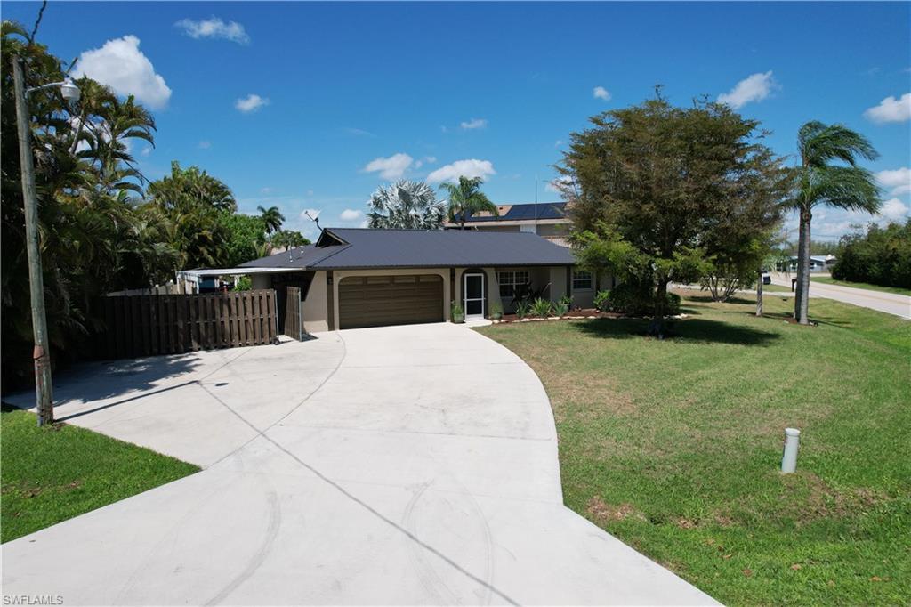Image 1: Ranch-style home with an attached garage and concrete driveway