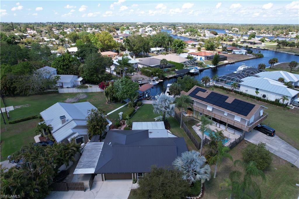 Image 2: Aerial perspective of suburban area featuring a large body of water