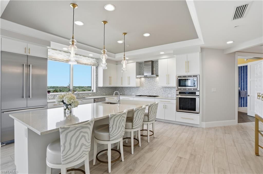 Image 3: Gas stovetop, a huge island, pendant lighting, TWO sinks and so much more!