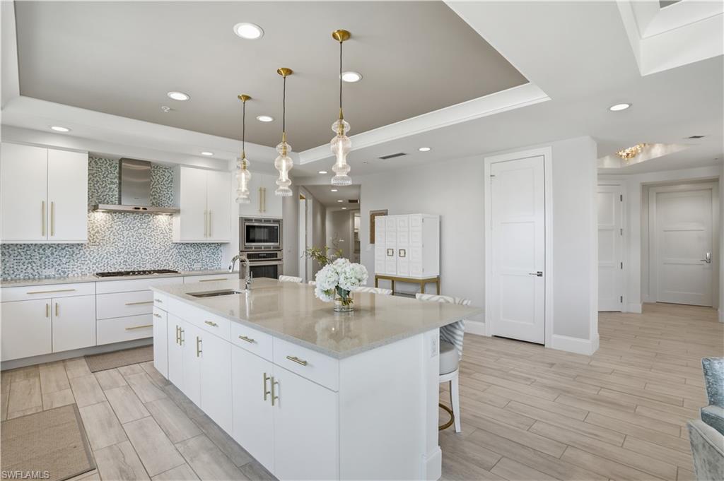 Image 4: Notice the hallway from the kitchen leading to the den and guest suites. This home allows so much privacy for owners and their guests!