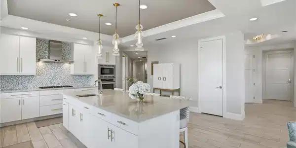 Image 4: Notice the hallway from the kitchen leading to the den and guest suites. This home allows so much privacy for owners and their guests!