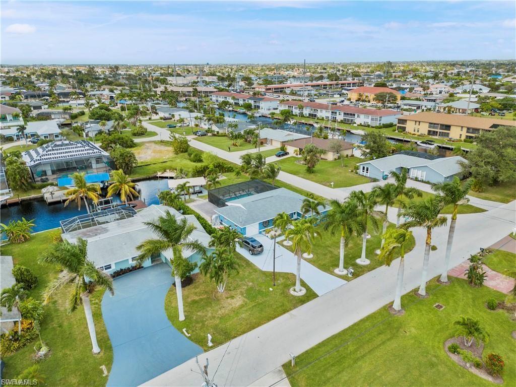 Image 3: Aerial perspective of suburban area featuring a nearby body of water