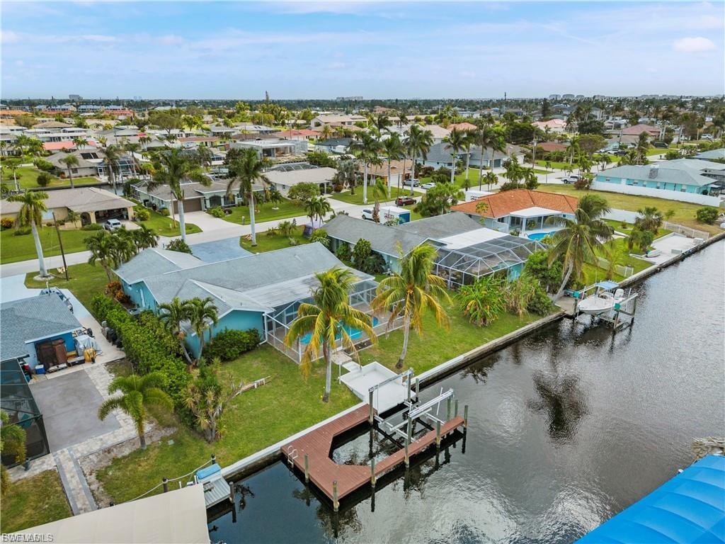 Image 4: Aerial perspective of suburban area with a large body of water