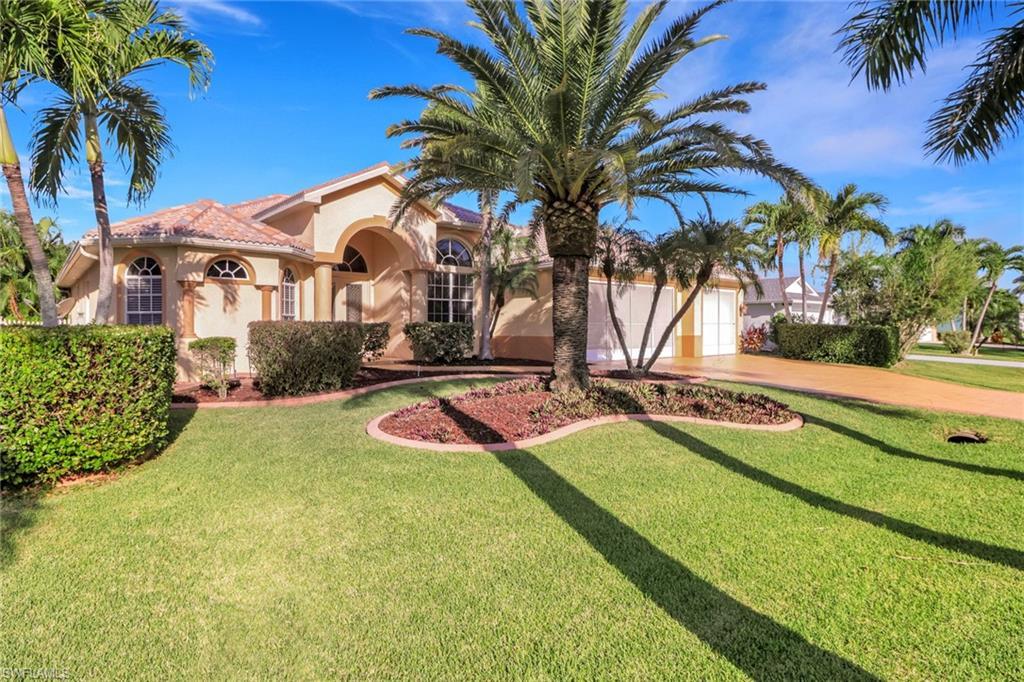 Image 2: Mediterranean / spanish house with stucco siding, driveway, and a front lawn