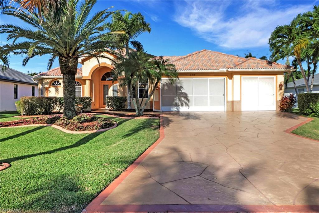 Image 3: View of front of home featuring a front lawn, a tiled roof, stucco siding, driveway, and an attached garage