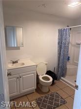Image 3: Bathroom with a stall shower, light tile patterned floors, and vanity