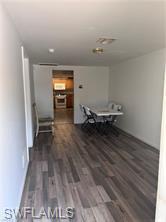 Image 4: Dining space featuring dark wood-style floors