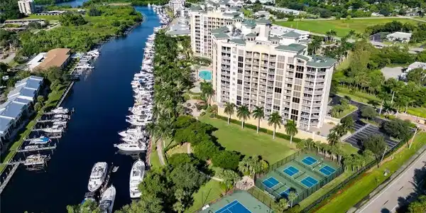 Image 3: Aerial view of a large body of water and apartment complex