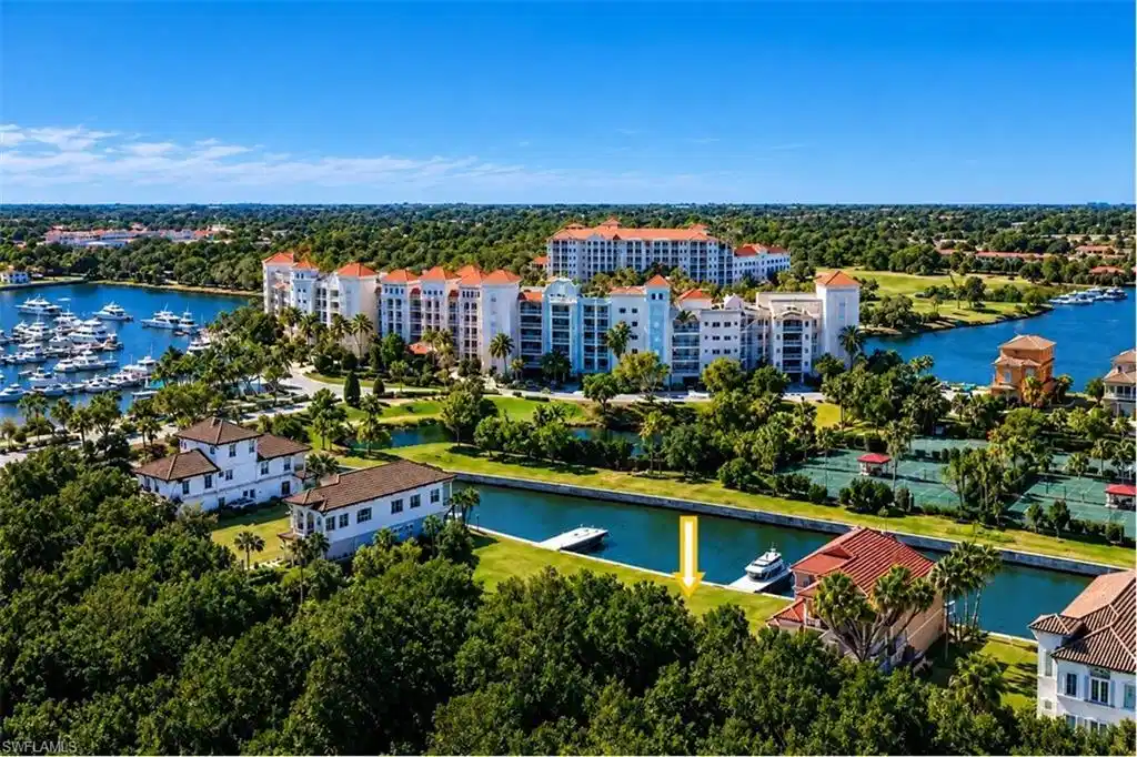Image 1: Waterfront property with private boat dock, lush landscaping, and proximity to marina