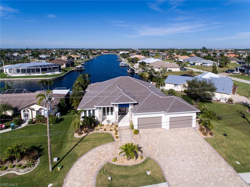 Image 2: Aerial view of residential area with a nearby body of water