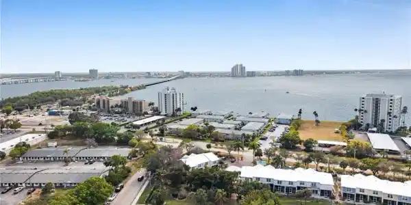 Image 2: View of urban area with a large body of water and a notable bridge