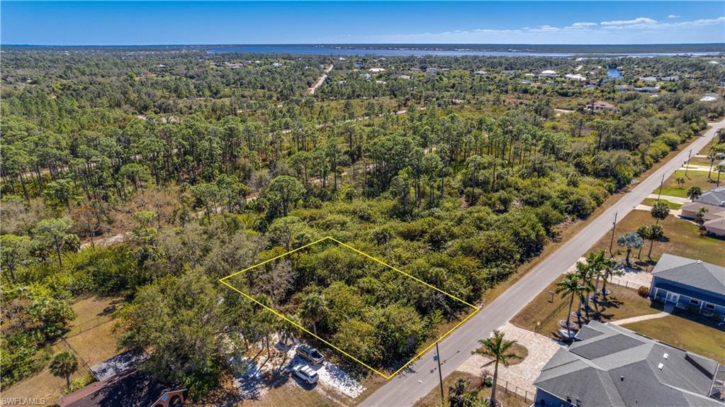 Image 4: View of property location with property parcel outlined and a heavily wooded area