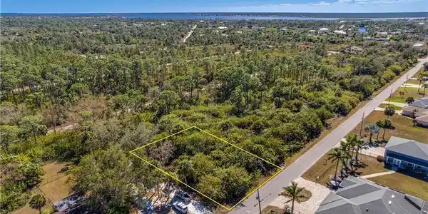 Image 4: View of property location with property parcel outlined and a heavily wooded area