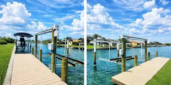Image 4: Dock featuring boat lift, a water view, and a yard