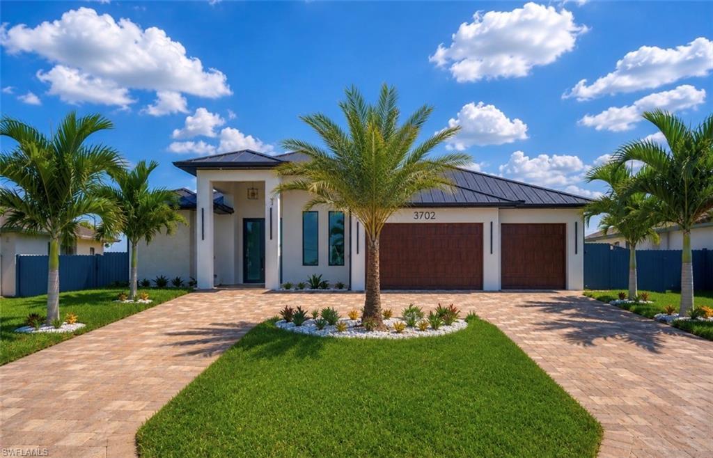 Image 1: Contemporary stucco exterior with a dark metal roof