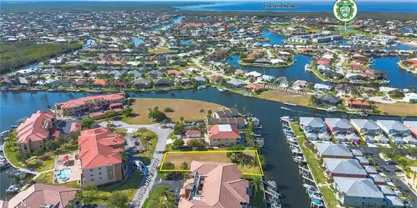 Image 3: Aerial perspective of suburban area with a nearby body of water and property boundaries highlighted